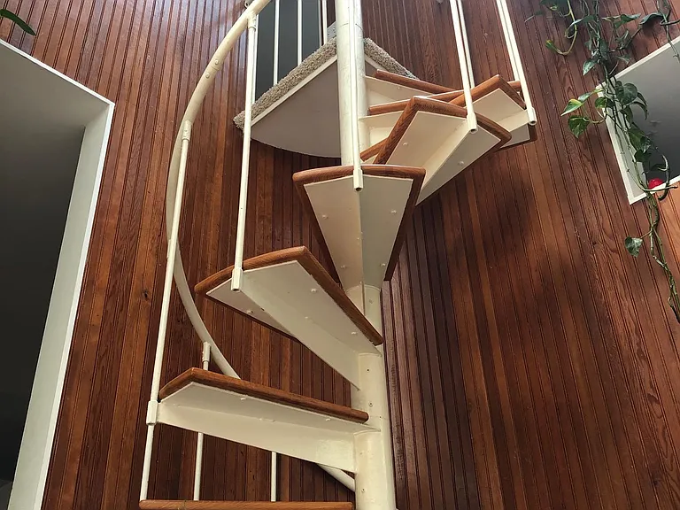 Spiral staircase, curved wall, and funky wall cut-outs
