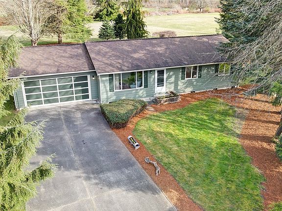 Here you see a glimpse of the back yard acreage beyond the home.   