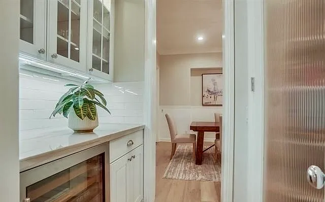 pantry, wine fridge/bar area between kitchen and dining room