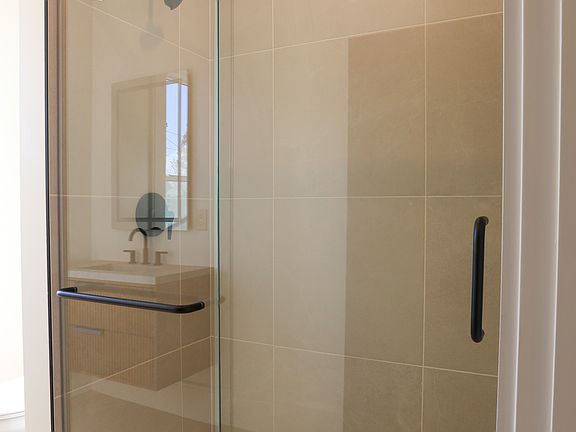 Tile shower with glass sliding doors give the bathroom a high end feel.