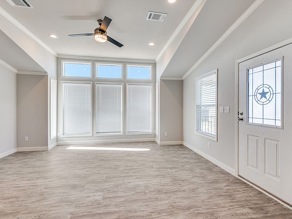 Living room features 20ft ceilings.