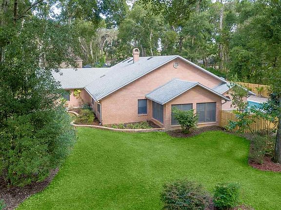 Gardens compliment this home with lush surroundings.