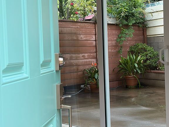 Upon opening the front door, one can look into the oasis-like back patio.