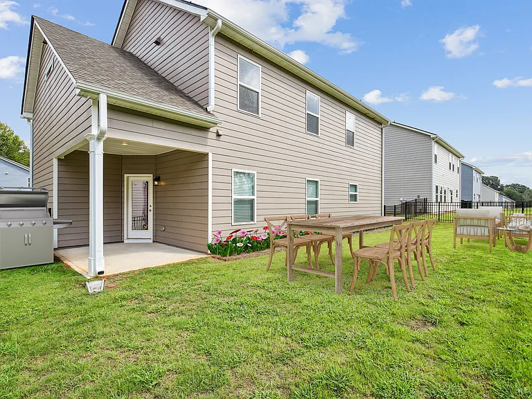 Covered back patio with fenced in yard.