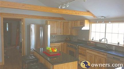 Modern Kitchen, marble counters, island, professional gas stove.