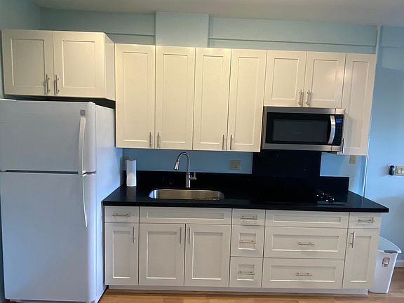 Fully equipped kitchen with quartz countertop, shaker cabinets with soft close drawers and doors. Electric radiant cooktop and microwave oven. Full size refrigerator.