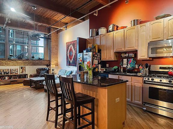 Kitchen with stainless steel appliances and breakfast bar