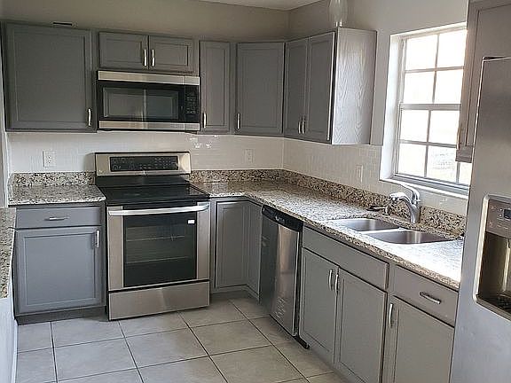 Granite countertops stainless steel appliances about a year old