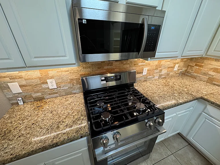 Kitchen detail - new gas range and new microwave with under cabinet lighting