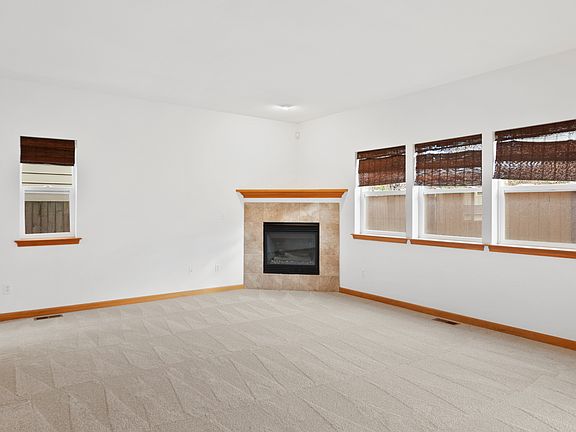 Large living room with gas fireplace and plenty of windows.