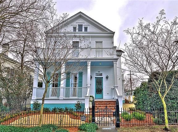 FRESHLY PAINTED EXTERIOR WITH NEW LANDSCAPING..SAFELY ENCLOSED WITH AN ORNATE WROUGHT IRON FENCE.