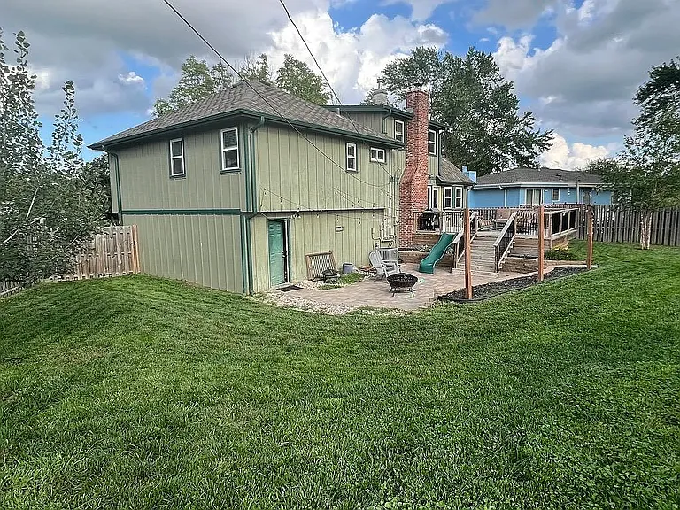 Large backyard with both patio and deck! (slide has been removed) Door on patio goes to garage, door on deck goes to dining room/family room with fireplace.