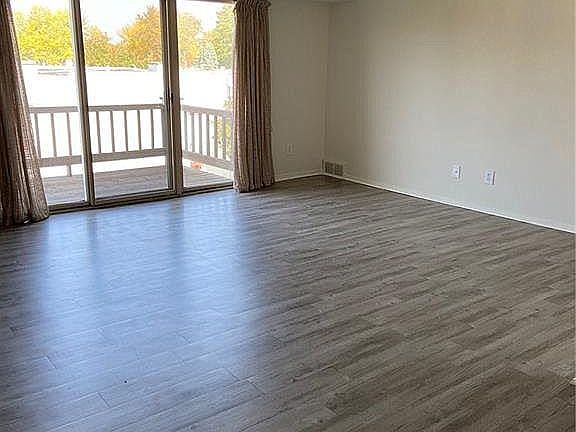 Living room freshly painted with high vaulted ceiling.