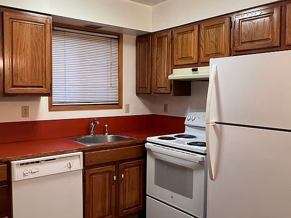 Kitchen houses new stove, refrigerator. Skylight in ceiling.