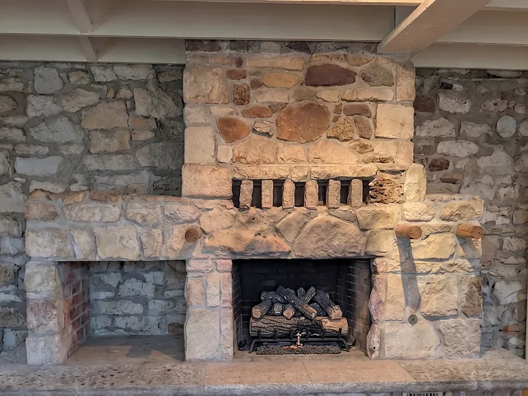 Original custom fireplace in the kitchen.