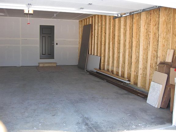 Extra deep 2 car garage with garage door opener and keypad. Garage is now fully insulated.