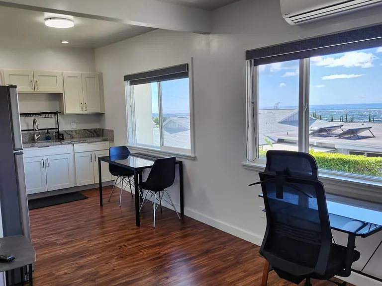 Large windows with views of Pearl Harbor. Custom Window shades to keep out the light when needed.
