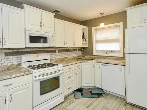 Kitchen has custom made mobile island