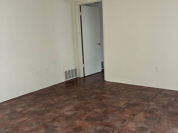 View of living room and entry to bedroom.