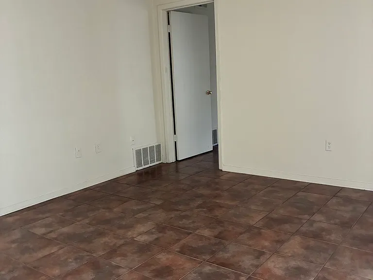 View of living room and entry to bedroom.