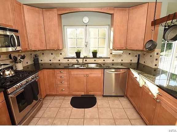 Gourmet kitchen with custom cabinets, granite counter tops, stainless appliances and tile flooring and back splash.