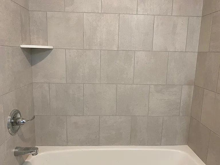 Tile surround tub in brand new bathroom as part of $125,000 remodel.