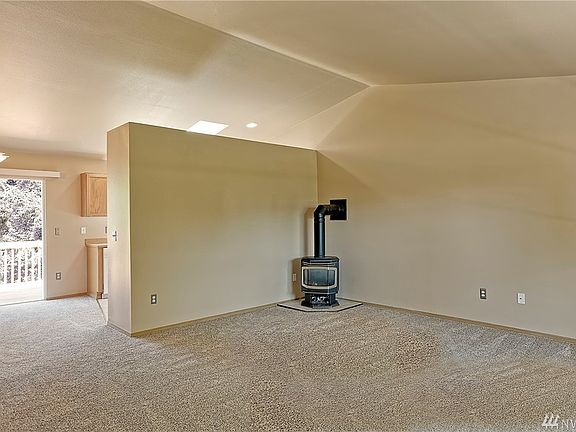 Free standing gas stove keeps the home toasty. The stove was just fully serviced. Receipts are in the house. Vaulted ceilings make the room appear even more spacious than it is.