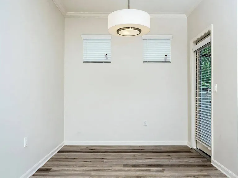 Bright Corner Dining Area with Private Patio Door and Windows