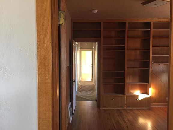 Built in bookshelves and hardwood floors.