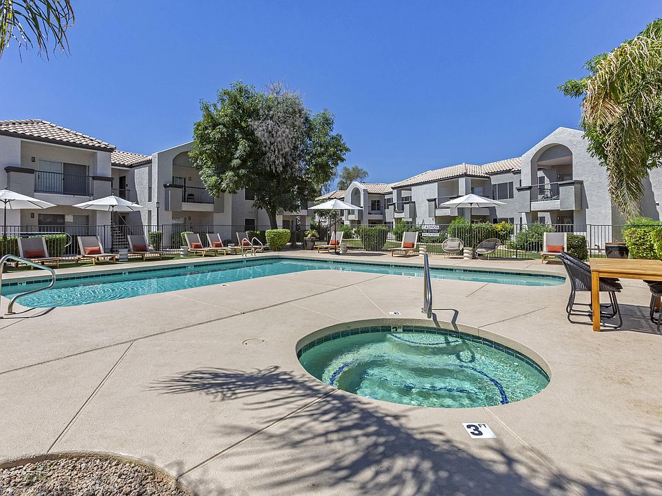 Dive into relaxation in our pool oasis with a hot tub and shaded lounging area