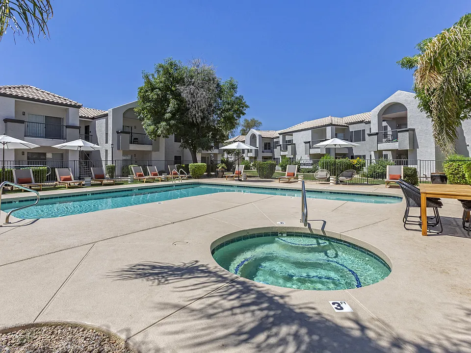 Dive into relaxation in our pool oasis with a hot tub and shaded lounging area