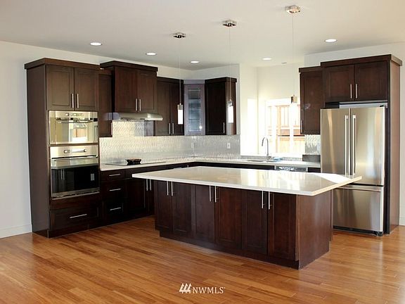 Large corner kitchen with lots of storage space and an extra large island that is the gathering point of the home