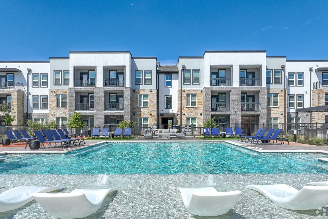 Resort Style Pool with Tan Deck and Loungers