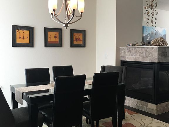 Dining room + gas fireplace to separate_ the living spaces.