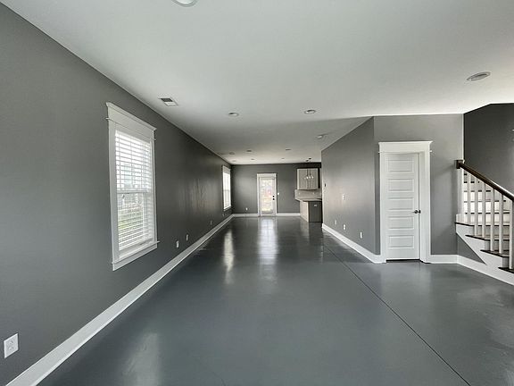 The closed door is the 1/2 bath. There is ample space to create a living room, workout or office area as well as a nice size dining table.