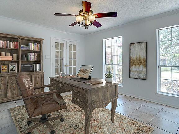 French doors lead you into the spacious 2nd living area with natural lighting & neutral colors. Would make a great home office!