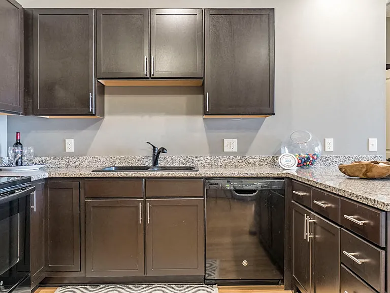 Our Espresso design style features rich, dark cabinetry and light granite countertops.