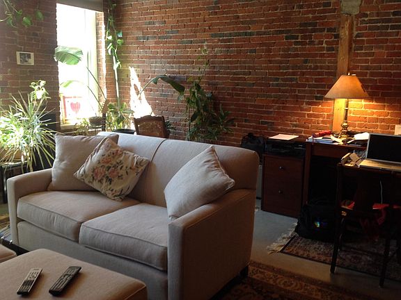 Living room love seat with ottomans.