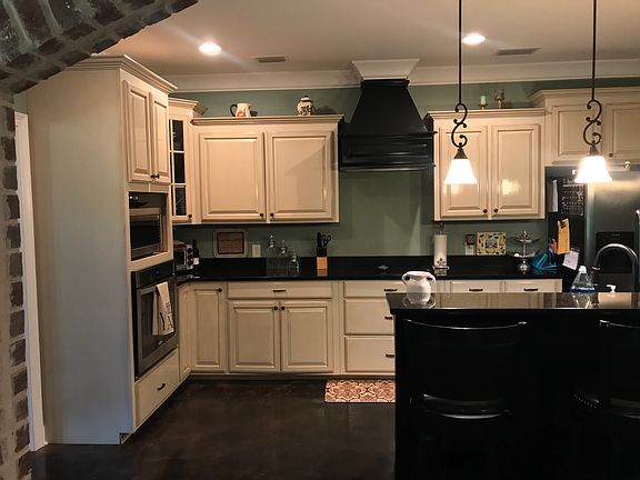 Open kitchen w/ brick arch