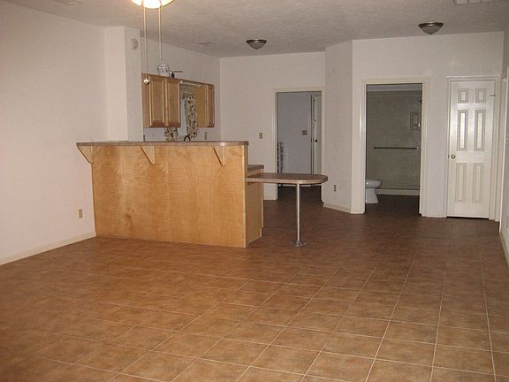 Living and kitchen area in second home, open plan, tile floors, tile throughou