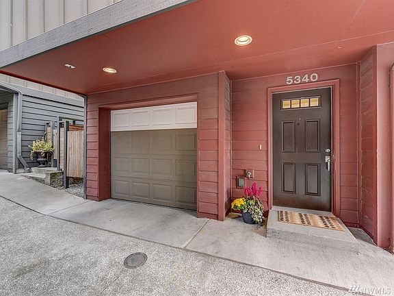 Front door entrance with one car garage and gate entrance to the back yard on the far left