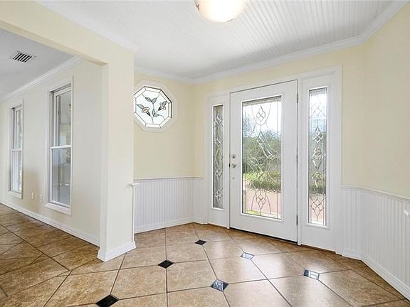 Bright entry with leaded glass door and beadboard ceilings