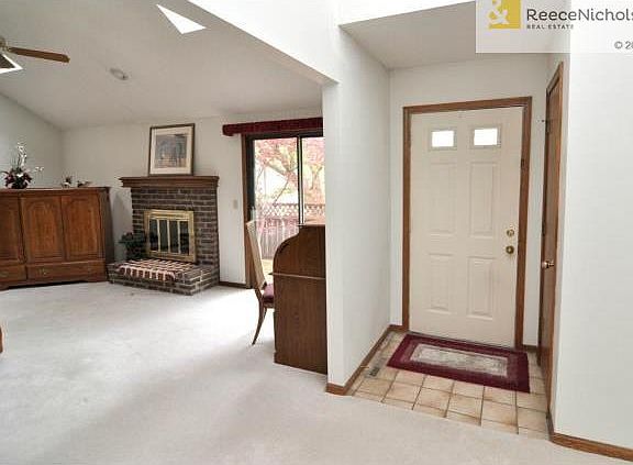 Welcoming entry with tile floor and coat closet
