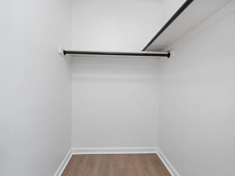 Explore this open and airy walk-in closet, perfect for organizing your wardrobe. Explore this open and airy walk-in closet, perfect for organizing your wardrobe.