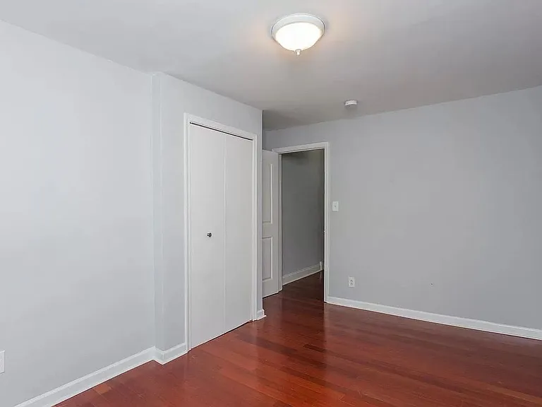 Unfurnished Back Bedroom with previous light fixture, Second View. Currently there is a ceiling fan with light