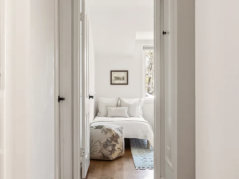 Third bedroom with two twin beds, built-in storage, and closet space, with a crib available upon request.