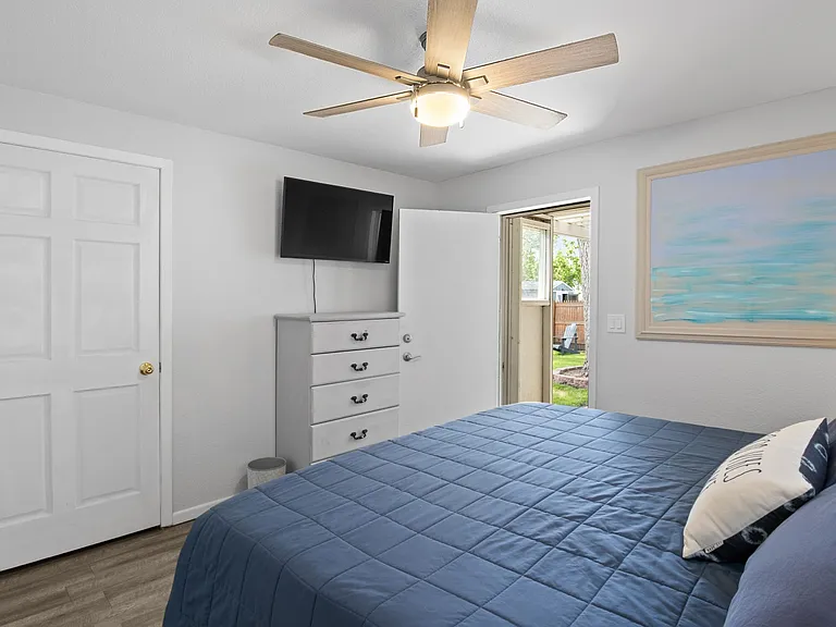 Primary bedroom with door to back porch