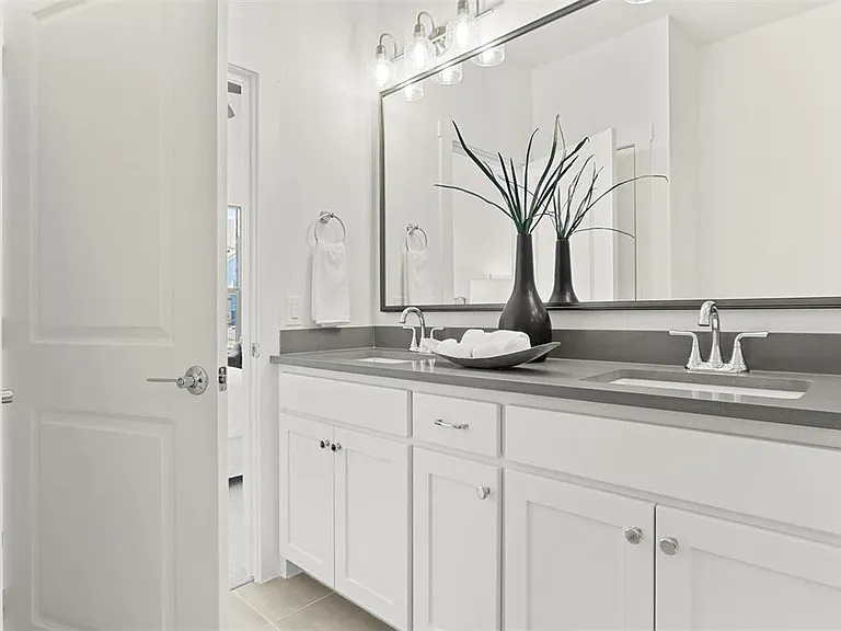 Enjoy a spa -inspired master bathroom with double sinks and a sleek glass shower.