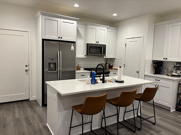 Kitchen as furnished by previous tenant.
(L-R) Door to garage, Kitchen, door to pantry
