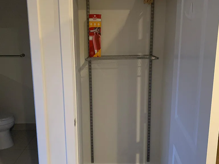 Additional closet space located between the larger walk-in closet and bathroom.